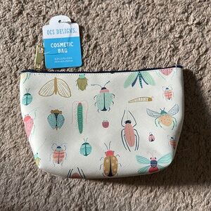OCS Designs white cosmetic bag with bug print